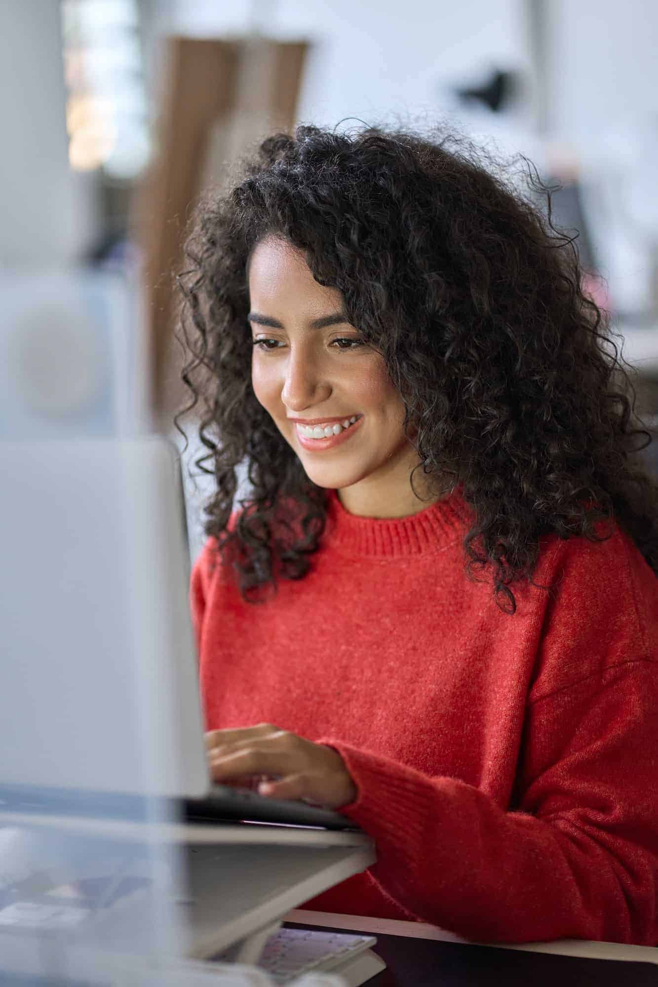Portfolio 3 young happy latin woman student elearning using laptop vertical shot